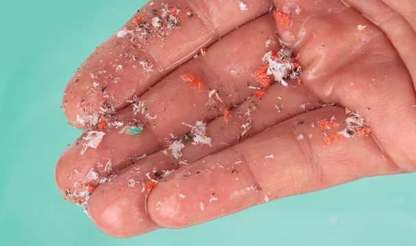 Hand holding microplastics